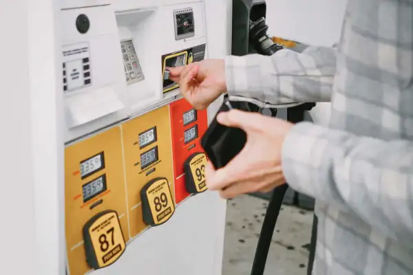 Close-up of unrecognizable white male man purchasing gas at pump