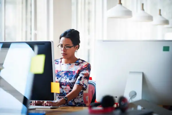 Woman In An Office Working On A Computer