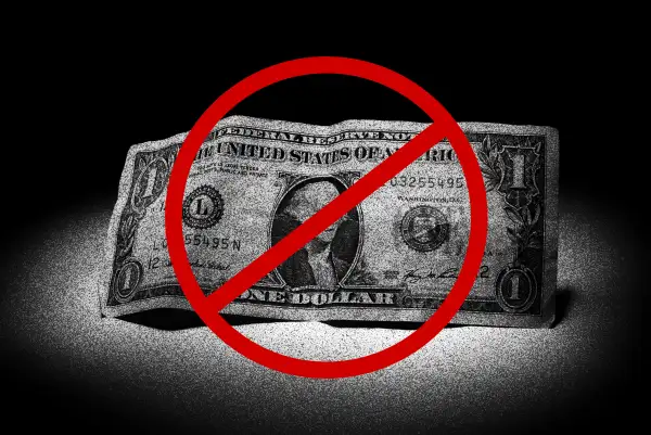 Image of a one dollar bill with a cancel sign