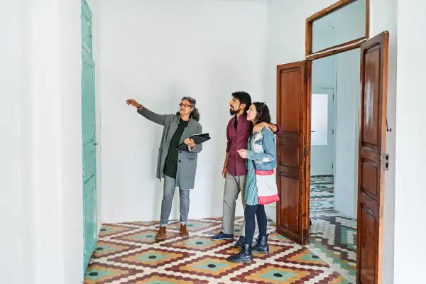 Couple and real estate agent examining rental options