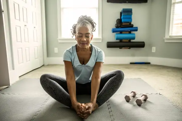 Older senior woman doing yoga