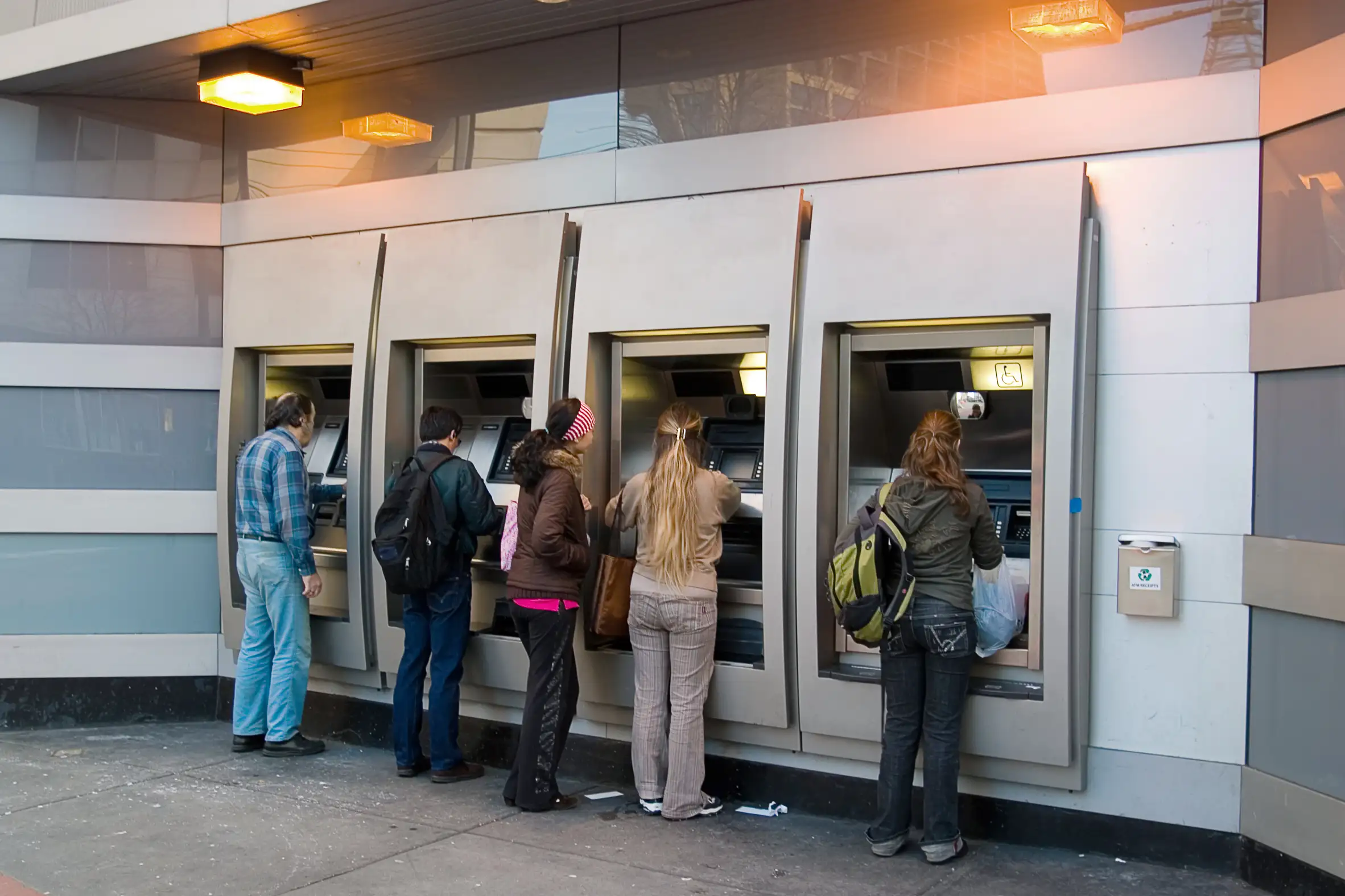 Multiple people withdrawing money from ATM machines