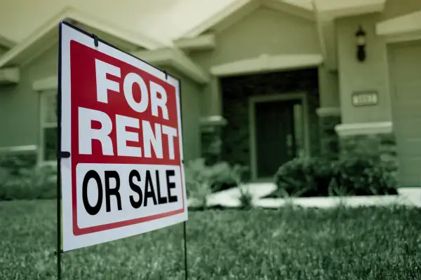 House with a sign that indicates it's for sale or for rent