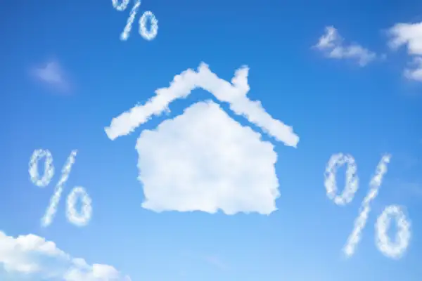 Photo illustration of house shaped cloud and percentage signs in the sky