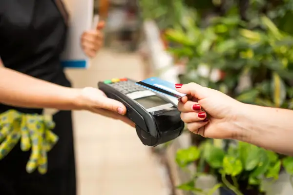 Close-up of a person paying with a credit card