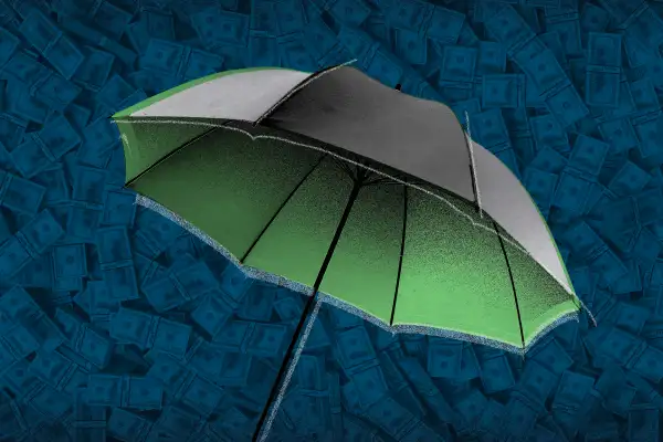 Photo illustration of an umbrella with cash in the background for a metaphor about life insurance cash outs