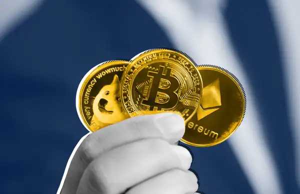 Close-up of a hand holding a dogecoin, bitcoin and ethereum coin