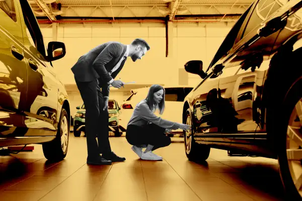 Woman inspecting a new car at car dealership