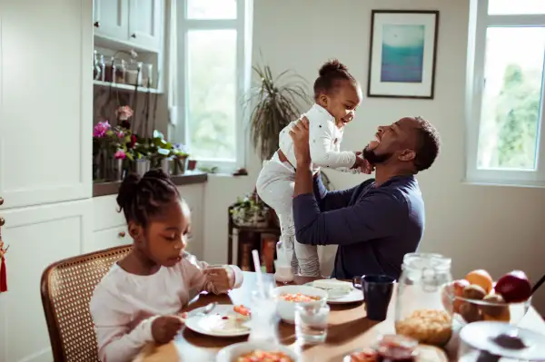 Father having breakfast with his two daughters