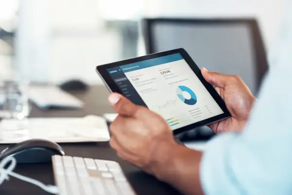 Close-up of a man using a smart tablet to use a management software