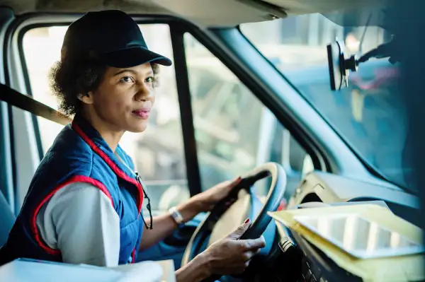 Woman courier driver making deliveries