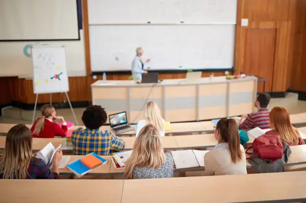 College students listening to a lecture in auditorium