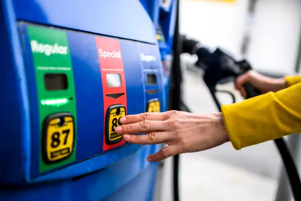 Close-up of a hand selecting the special fuel at the gas pump