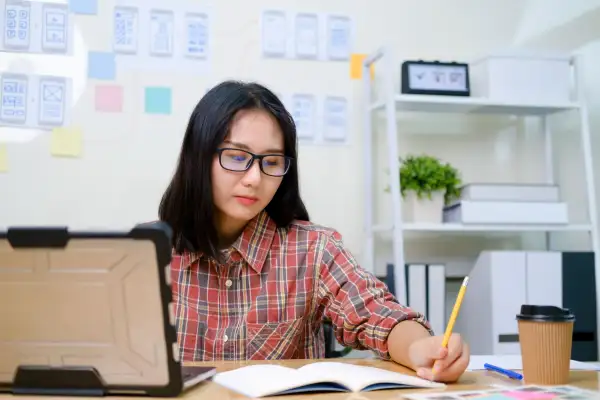 Woman UX designer working on her laptop to build a website