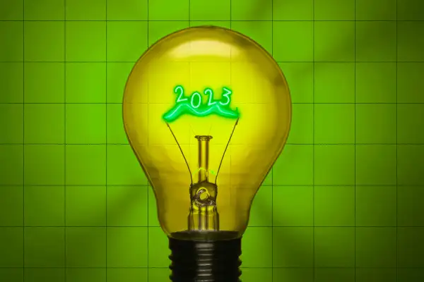 Photo-Illustration of a light bulb with the year 2023 lit from inside