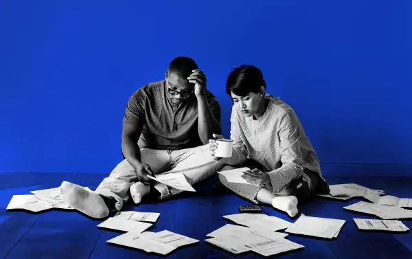 Couple looking through multiple receipts with a worried look