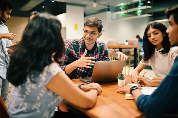 Group of young people discussing in the co-working office