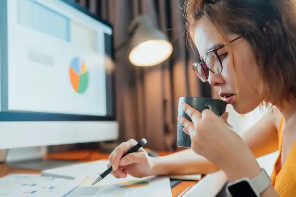 Woman looking over balance sheets and business expenses