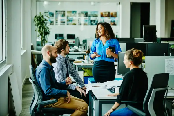 Businesswoman leading meeting with colleagues