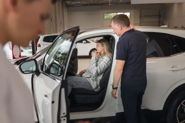 Woman shopping for a new car at a car dealership