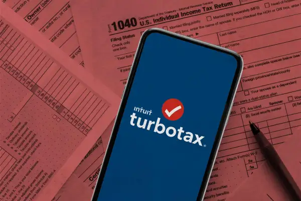 Smartphone with Turbotax logo on screen on top of a 1040 tax document