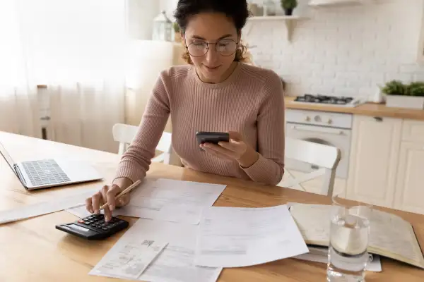 Millennial hispanic businesswoman do paperwork pay bills at home office