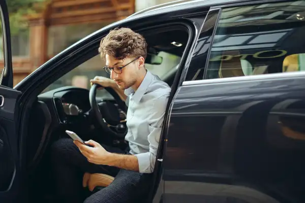 Man on cellphone inside his car