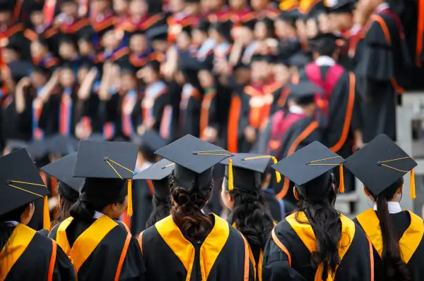 Graduates are stand up in line to get your degree ,vintage style,graduates cap behind isolated