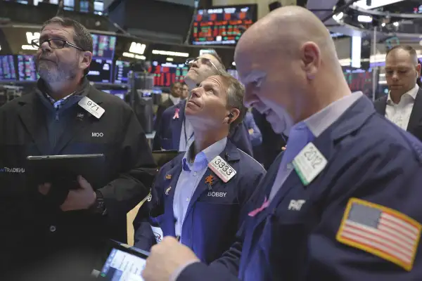 Traders work on the floor of the New York Stock Exchange on Wall Street in New York City