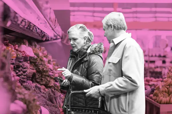 Senior couple shopping for vegetables at supermarke