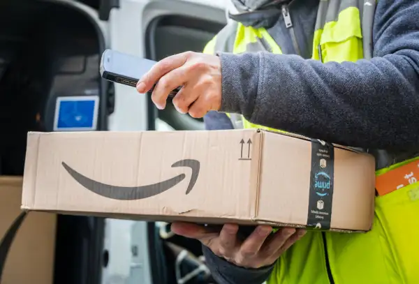 Amazon Prime delivery agent scanning barcodes on boxes during his work shift