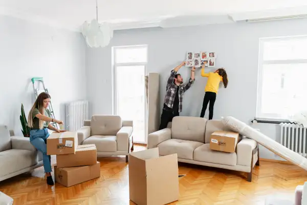 Family of three moving into an apartment and unpacking boxes