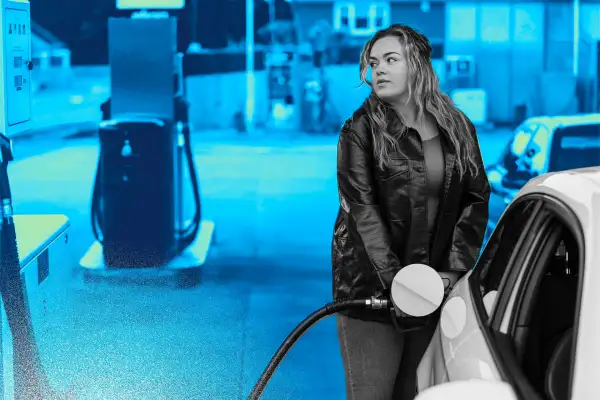 Photo of a woman pumping gas