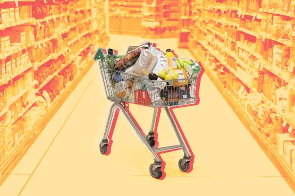 Full shopping cart in supermarket aisle