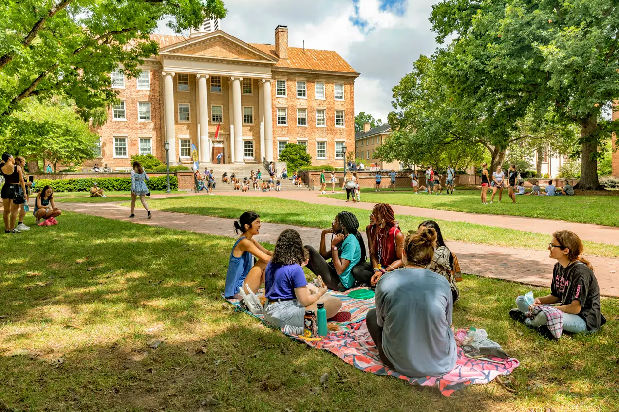 group of students sitting on the lawn at The University of North Carolina at Chapel Hill