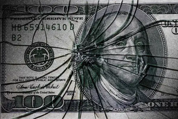 Illustration of a dollar broken as a piece of glass
