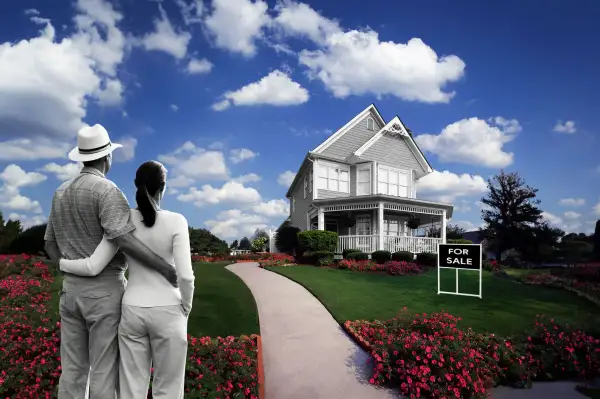 Photo Illustration of a couple looking at a beautiful house with a for sale sign