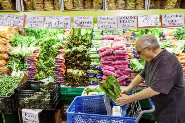 Man in a grocery store in the produce section