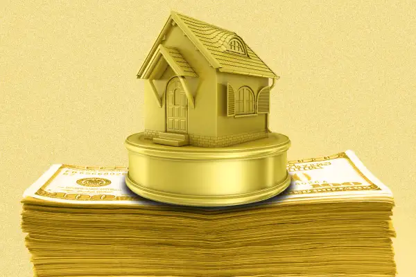 Photo-illustration of a house-shaped trophy on a stack of cash
