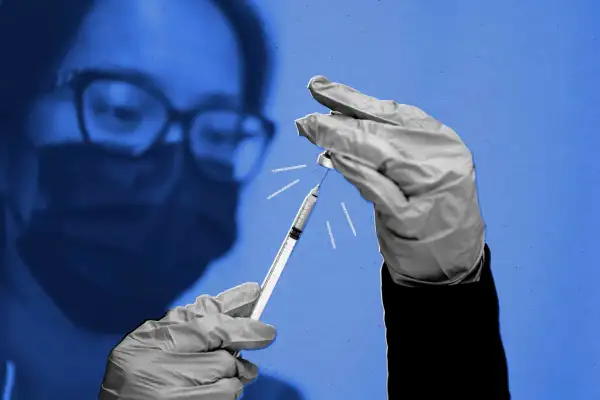 Photo of a nurse preparing a booster shot