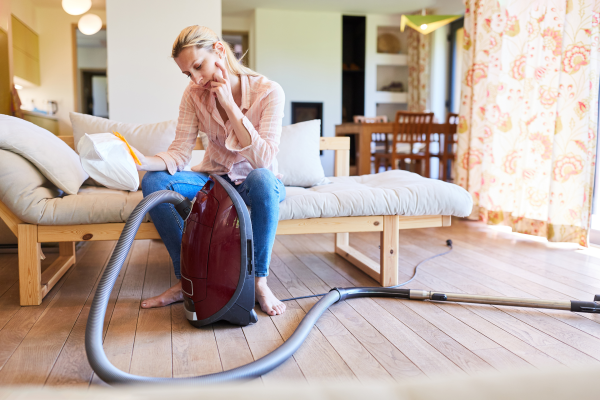 Cleaning Lady with Vacuum Cleaner and Vacuum Cleaner Bag