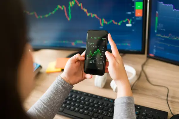 Woman checking the stock market in her phone