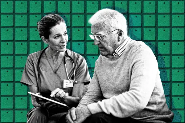 A doctor helping a senior man sign up for health insurance