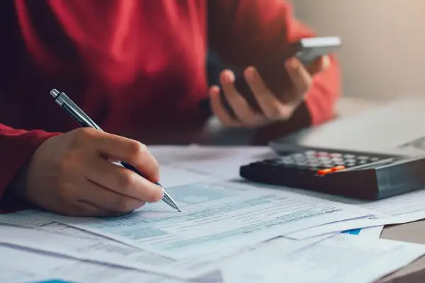 Person filling out tax forms