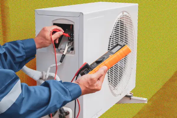 Air conditioner technician checking air conditioner operation