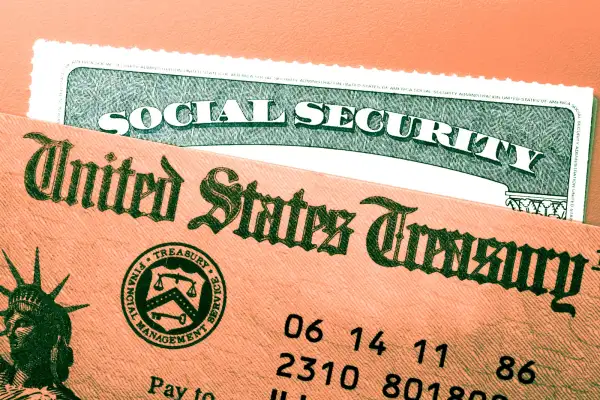 A United States Treasury government check rests on top of a Social Security card.