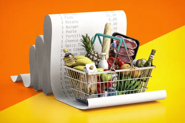 Photo Illustration of a shopping basket full of groceries on top of a long receipt