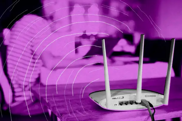 Photo illustration of an internet router being used at home by a costumer