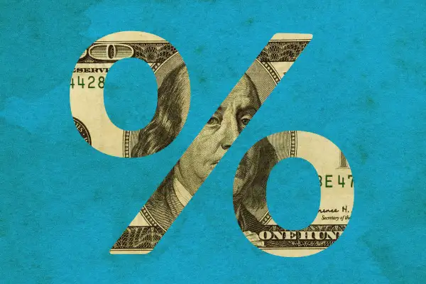 Photo Illustration of a hundred dollar bill cut into a percentage sign