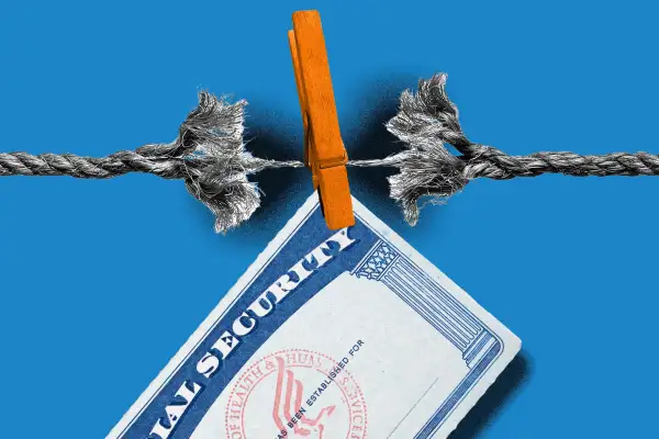 A torn rope with a Social Security card hanging from a clothespin.